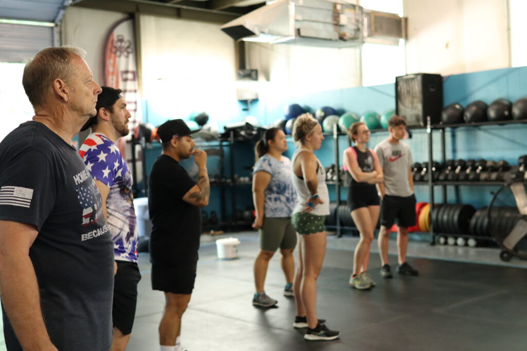 Group of athletes of varying ages, getting ready to do a CrossFit Workout